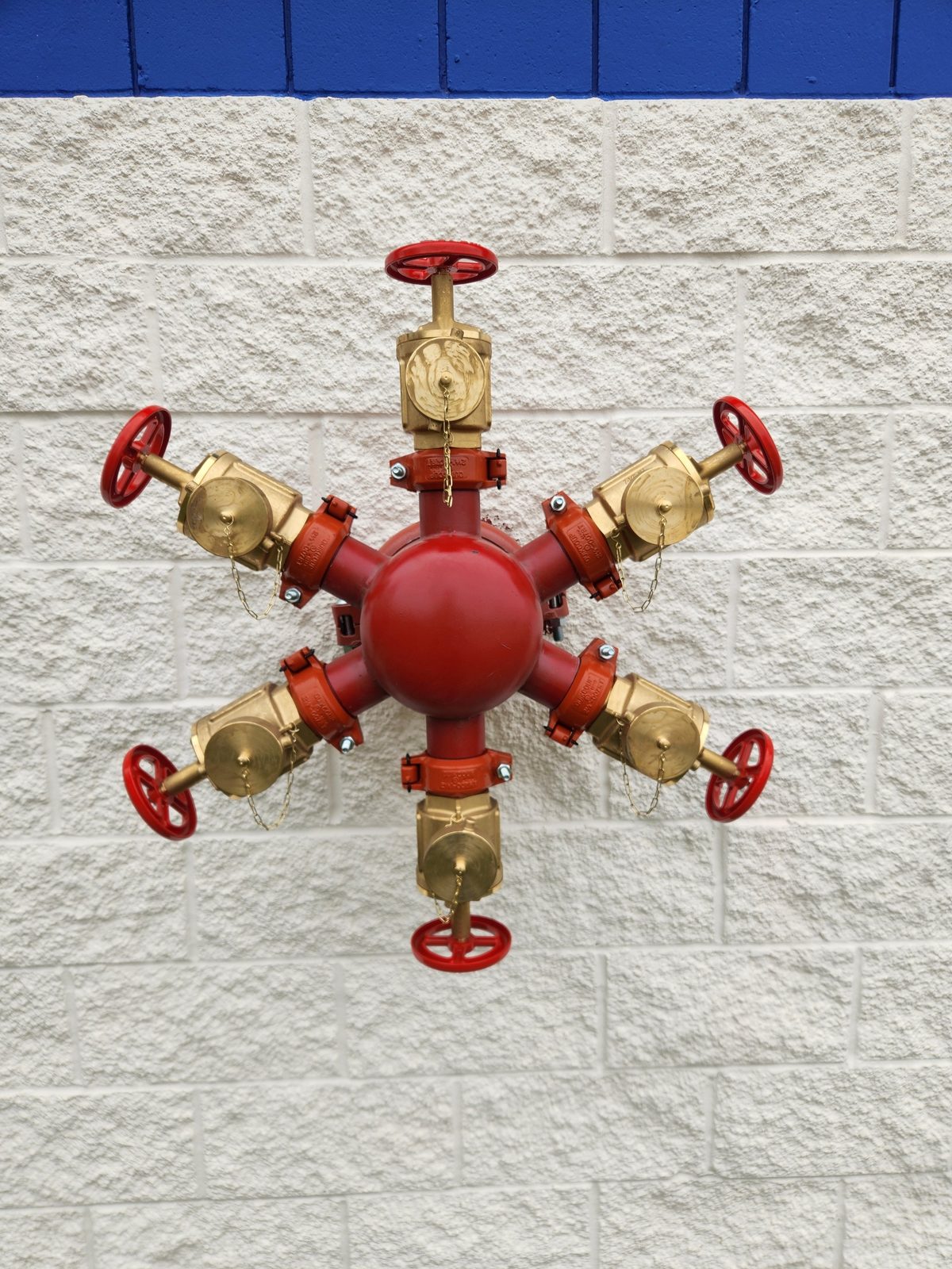 Six-way fire department connection on a block wall