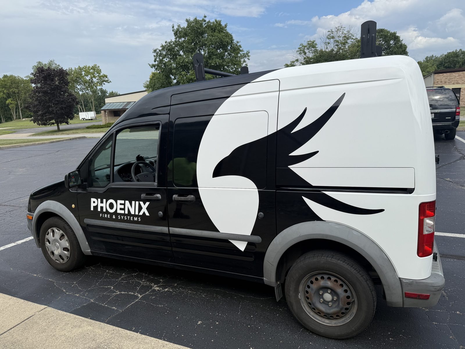 Phoenix Fire & Systems service van with the company wordmark and phoenix logo
